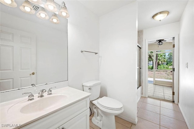 bathroom with vanity, bath / shower combo with glass door, toilet, baseboards, and tile patterned flooring