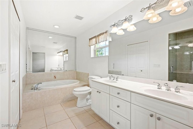 full bathroom with a bath, a sink, tile patterned floors, and visible vents