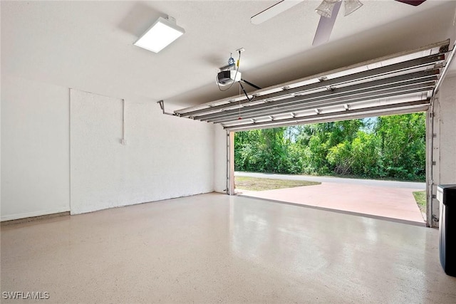 garage featuring ceiling fan and a garage door opener
