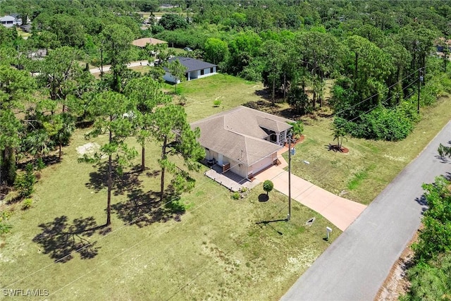 drone / aerial view with a wooded view