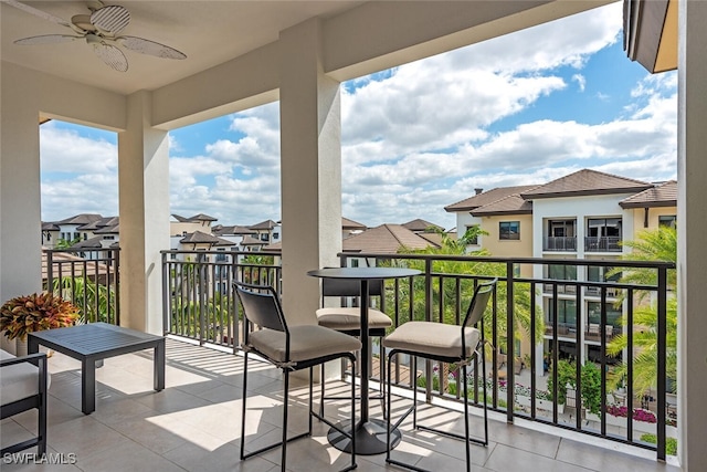 balcony featuring a ceiling fan and a residential view