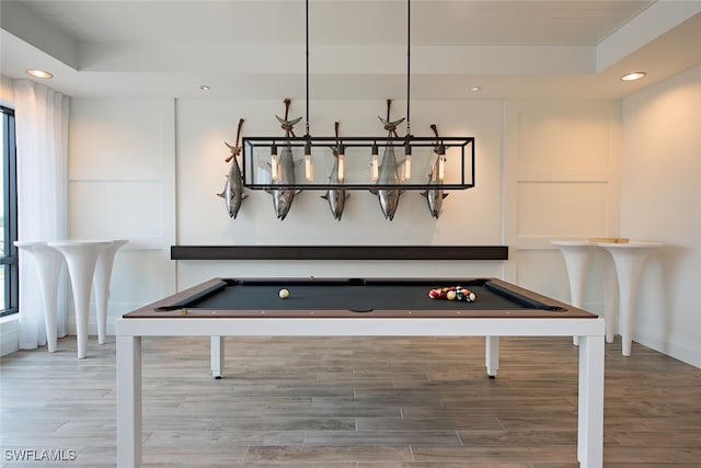 game room with recessed lighting, a raised ceiling, wood finished floors, and pool table