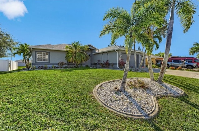 1103 SW 8th Ct, Cape Coral, FL 33991 - ranch-style home with a front yard, driveway, a garage, and stucco siding