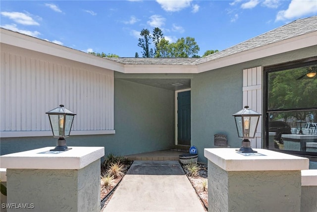 view of exterior entry with stucco siding
