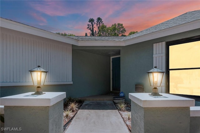 entrance to property with stucco siding