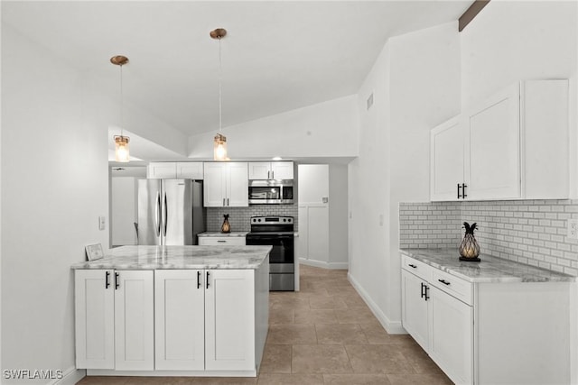 kitchen featuring white cabinets, appliances with stainless steel finishes, a peninsula, lofted ceiling, and tasteful backsplash