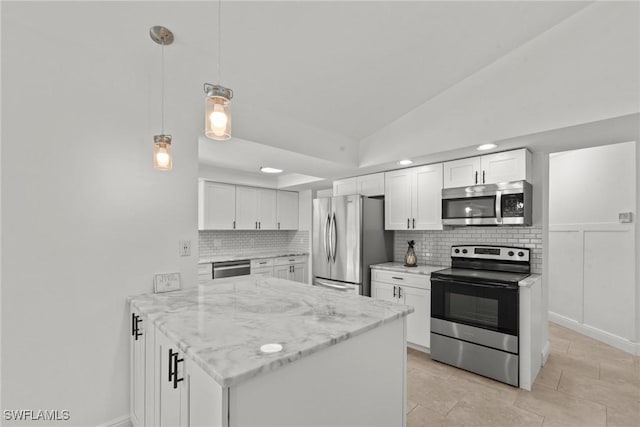 kitchen with backsplash, stainless steel appliances, a peninsula, and white cabinetry