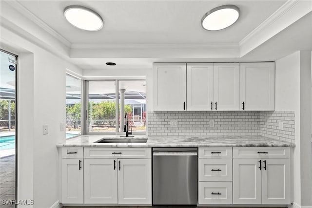 kitchen featuring stainless steel dishwasher, a sink, baseboards, and a raised ceiling