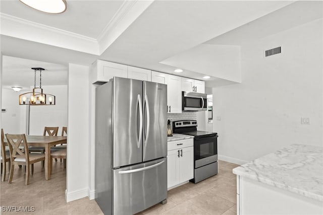 kitchen featuring appliances with stainless steel finishes, ornamental molding, decorative backsplash, and white cabinets