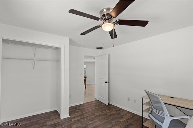 office with baseboards, ceiling fan, wood finished floors, and visible vents