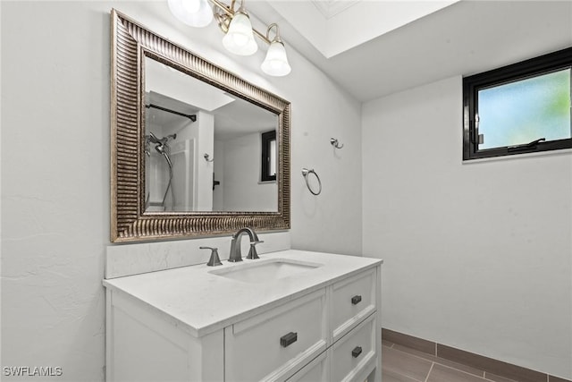bathroom with a skylight and vanity