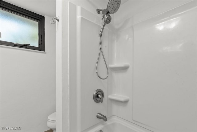 bathroom with toilet and shower / washtub combination