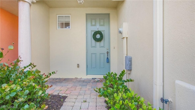 doorway to property with stucco siding