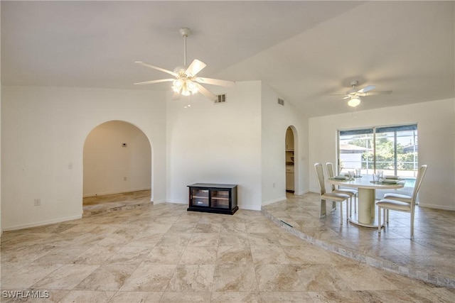 unfurnished dining area with arched walkways, ceiling fan, and baseboards