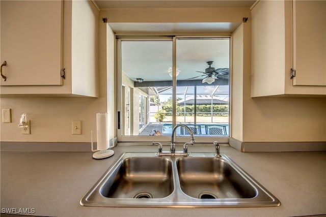 kitchen featuring a sink, light countertops, and ceiling fan