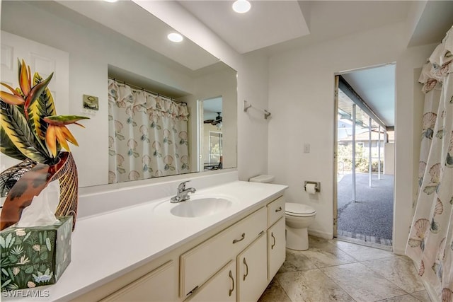full bath with toilet, vanity, and recessed lighting