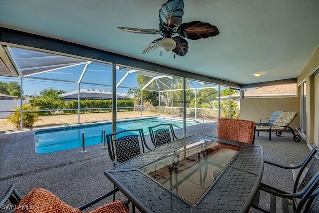 outdoor pool featuring a patio area, outdoor dining space, and a lanai