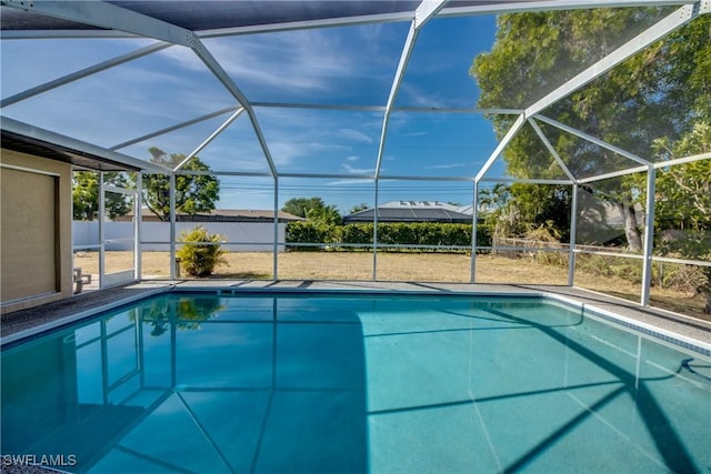 view of swimming pool with glass enclosure