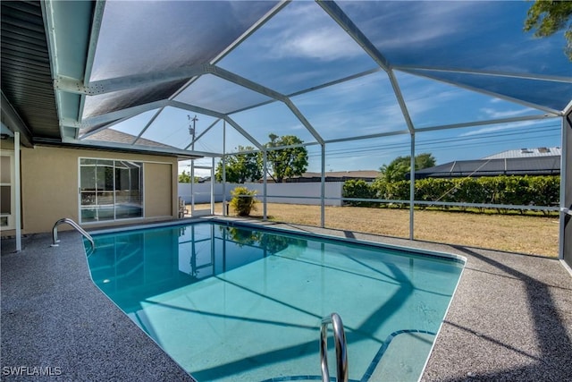 view of swimming pool featuring a patio and glass enclosure