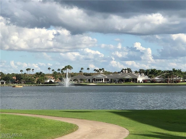 view of community with a lawn and a water view