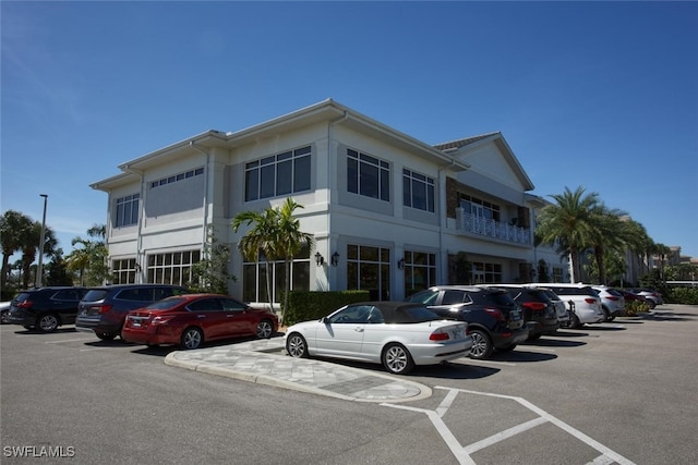 view of building exterior with uncovered parking