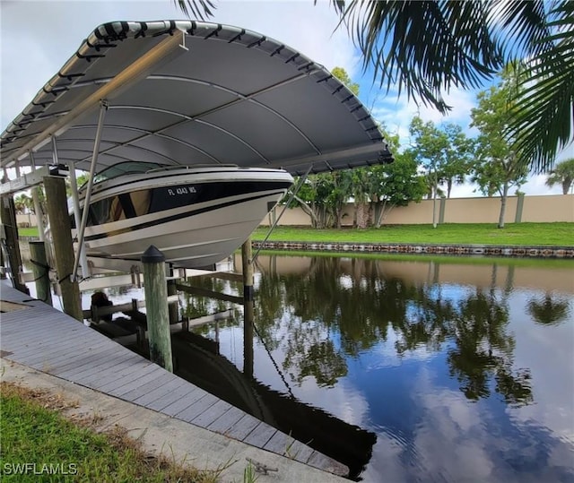 view of dock featuring boat lift and a water view