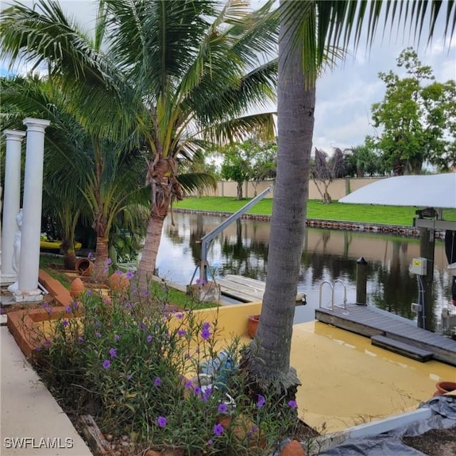 dock area featuring a water view and fence