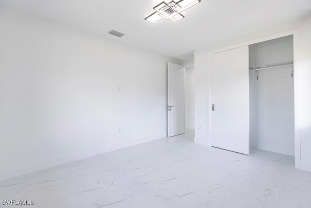 1111 SW Embers Ter, Cape Coral, FL 33991 - unfurnished bedroom featuring light marble finish floors, baseboards, and a closet