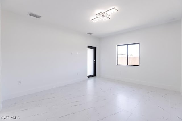 1111 SW Embers Ter, Cape Coral, FL 33991 - spare room featuring light marble finish floors and baseboards