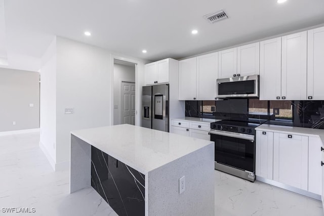 1111 SW Embers Ter, Cape Coral, FL 33991 - kitchen featuring stainless steel appliances, recessed lighting, decorative backsplash, light marble finish flooring, and light stone countertops