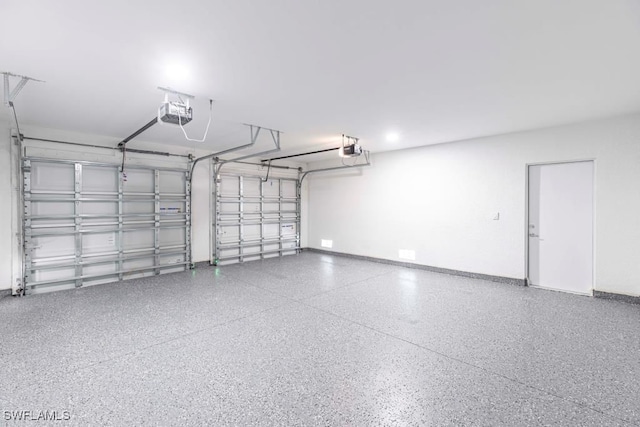 1111 SW Embers Ter, Cape Coral, FL 33991 - garage featuring a garage door opener and baseboards