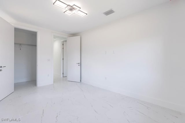 1111 SW Embers Ter, Cape Coral, FL 33991 - unfurnished bedroom featuring light marble finish flooring, baseboards, and a closet
