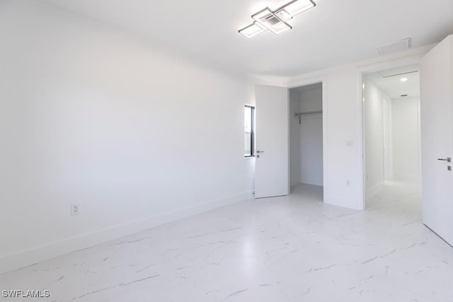 1111 SW Embers Ter, Cape Coral, FL 33991 - unfurnished bedroom with a closet, baseboards, and light marble finish flooring