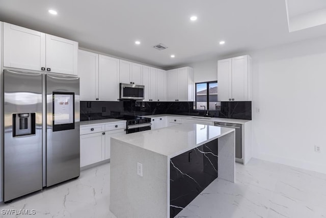 1111 SW Embers Ter, Cape Coral, FL 33991 - kitchen featuring appliances with stainless steel finishes, a sink, tasteful backsplash, white cabinetry, and recessed lighting