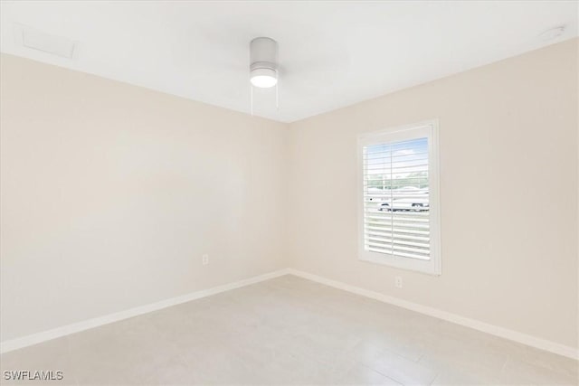 3210 31st St W, Lehigh Acres, FL 33971 - spare room with baseboards, a ceiling fan, and light tile patterned floors