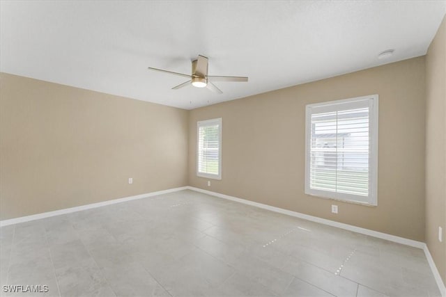 3210 31st St W, Lehigh Acres, FL 33971 - empty room with baseboards, a ceiling fan, and light tile patterned flooring