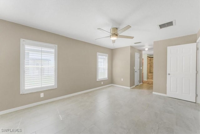 3210 31st St W, Lehigh Acres, FL 33971 - unfurnished bedroom with connected bathroom, baseboards, visible vents, and ceiling fan