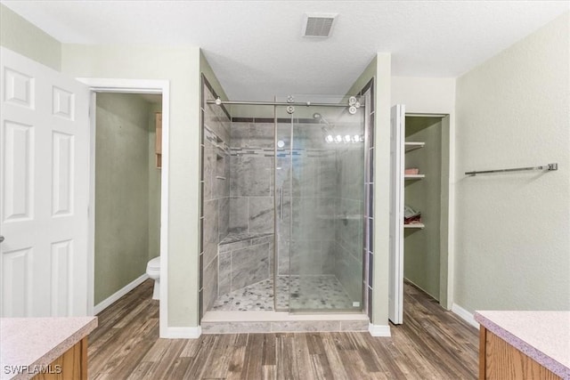 3210 31st St W, Lehigh Acres, FL 33971 - bathroom with visible vents, a stall shower, toilet, and wood finished floors