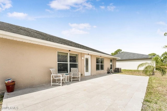 3210 31st St W, Lehigh Acres, FL 33971 - rear view of property featuring a patio, stucco siding, and cooling unit