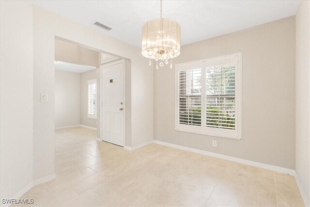 3210 31st St W, Lehigh Acres, FL 33971 - spare room featuring baseboards, a notable chandelier, visible vents, and light tile patterned floors