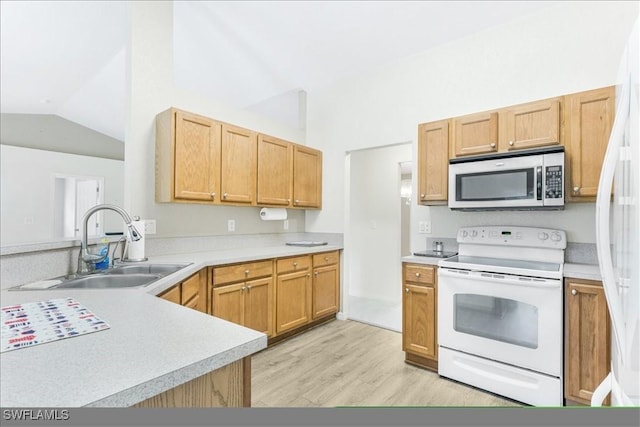 3210 31st St W, Lehigh Acres, FL 33971 - kitchen with white electric range oven, a sink, light wood-style flooring, stainless steel microwave, and lofted ceiling