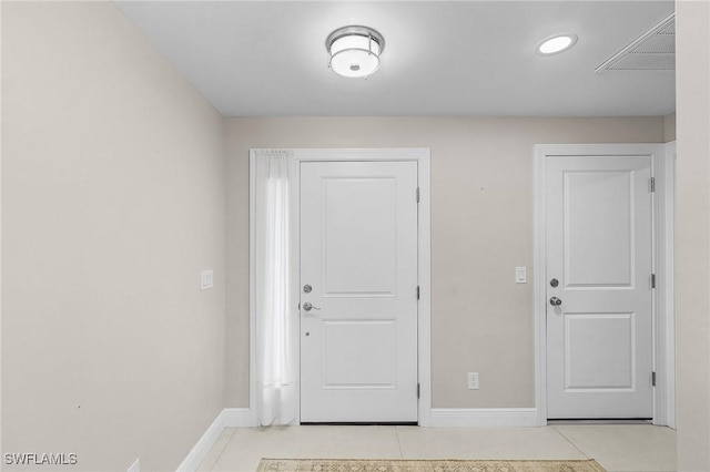 entryway with light tile patterned flooring, visible vents, and baseboards