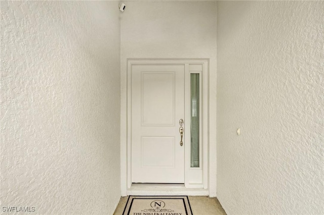 property entrance featuring stucco siding