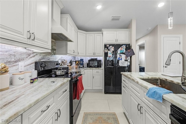 kitchen featuring white cabinets, a sink, visible vents, black appliances, and light tile patterned flooring