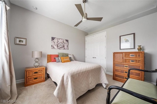 carpeted bedroom with baseboards, a ceiling fan, and a closet