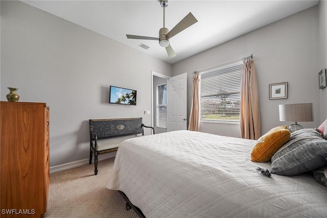 carpeted bedroom featuring visible vents, ceiling fan, and baseboards