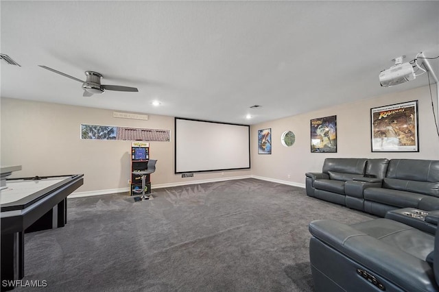 home theater room with baseboards, visible vents, dark carpet, and a ceiling fan