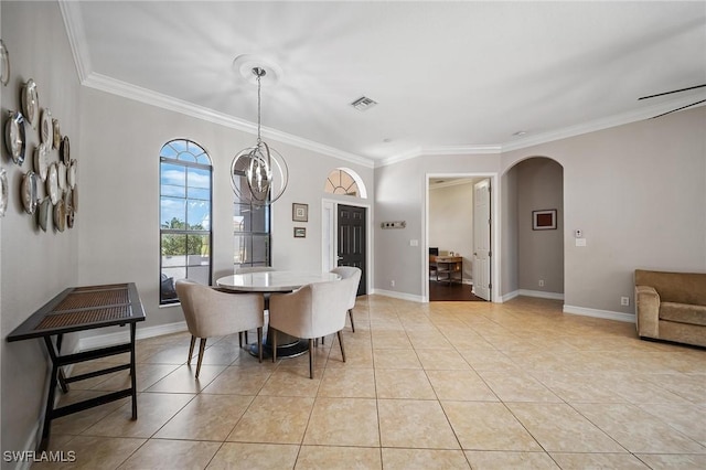 dining room featuring an inviting chandelier, visible vents, ornamental molding, and arched walkways
