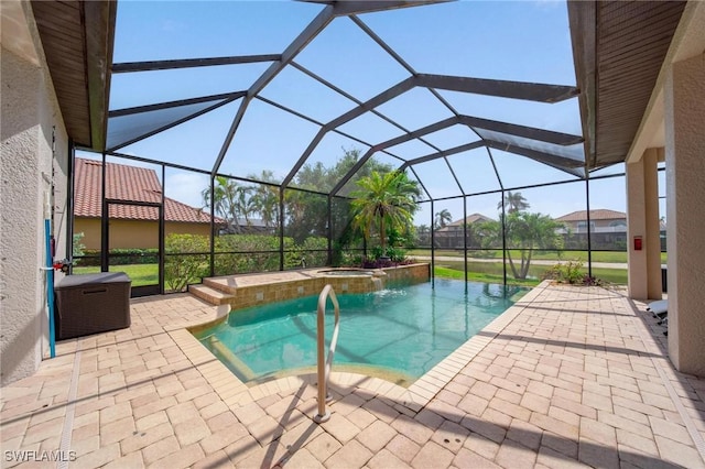 view of pool with a lanai, a pool with connected hot tub, and a patio area