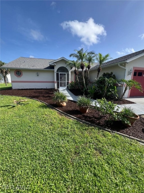 2875 18th Ave SE, Naples, FL 34117 - ranch-style home featuring a garage, stucco siding, driveway, and a front yard